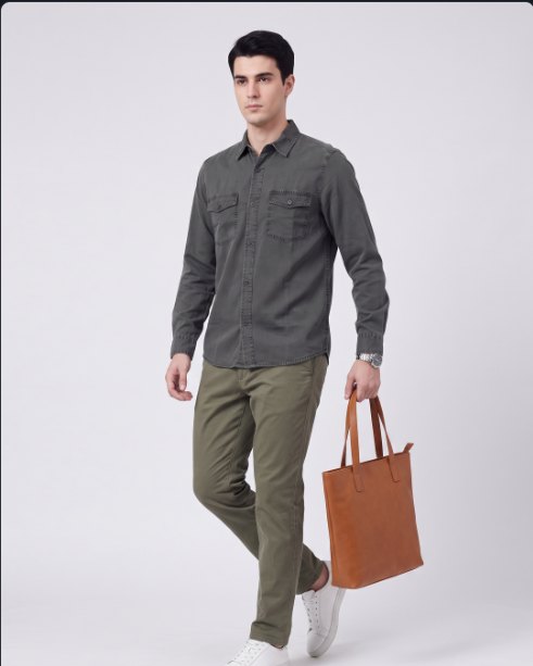 The same grey cargo shirt generated on a model with olive chinos and a tan tote